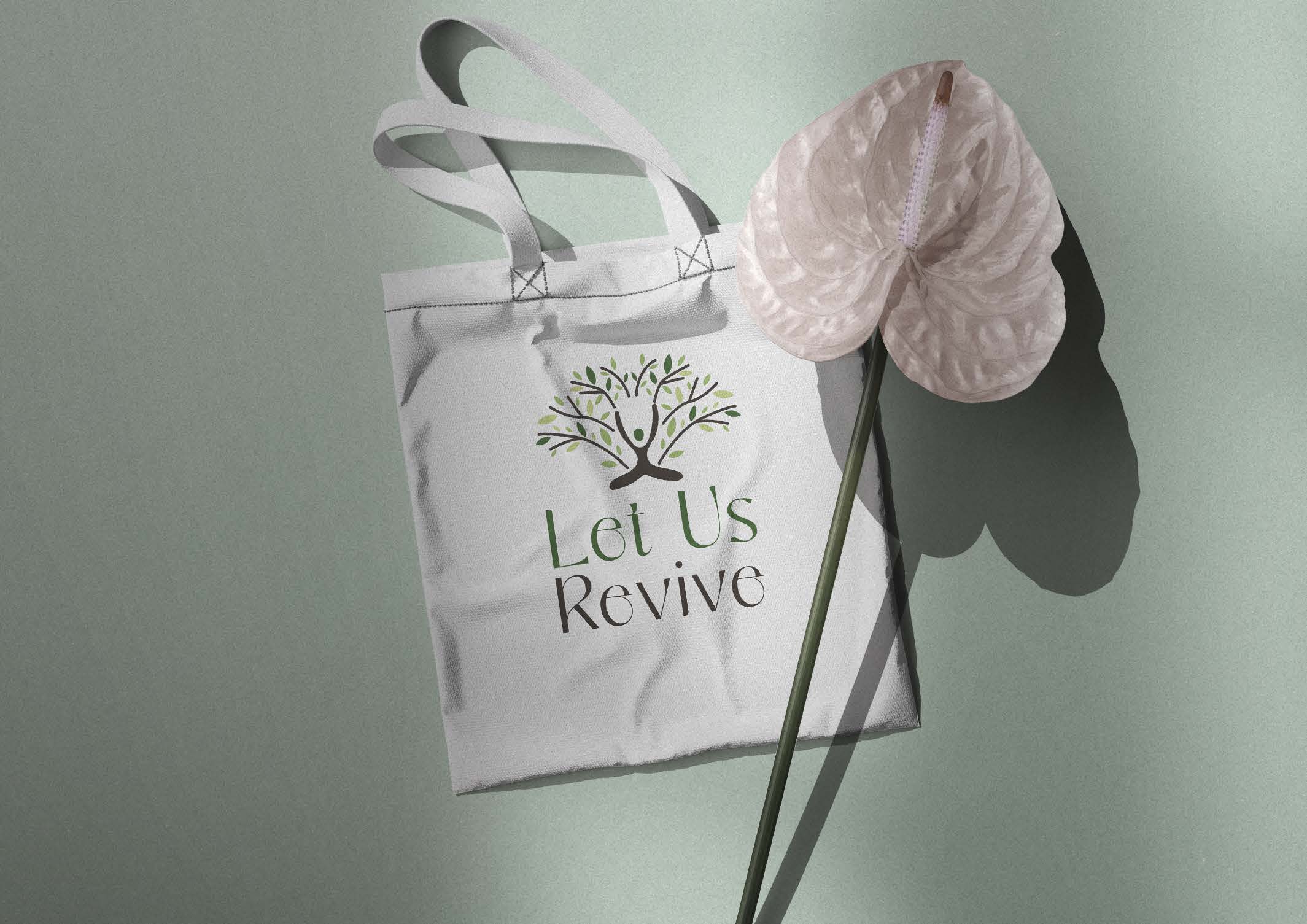 Let Us Revive green identity applied to a reusable tote bag