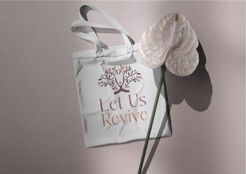 Let Us Revive pink identity applied to a reusable tote bag
